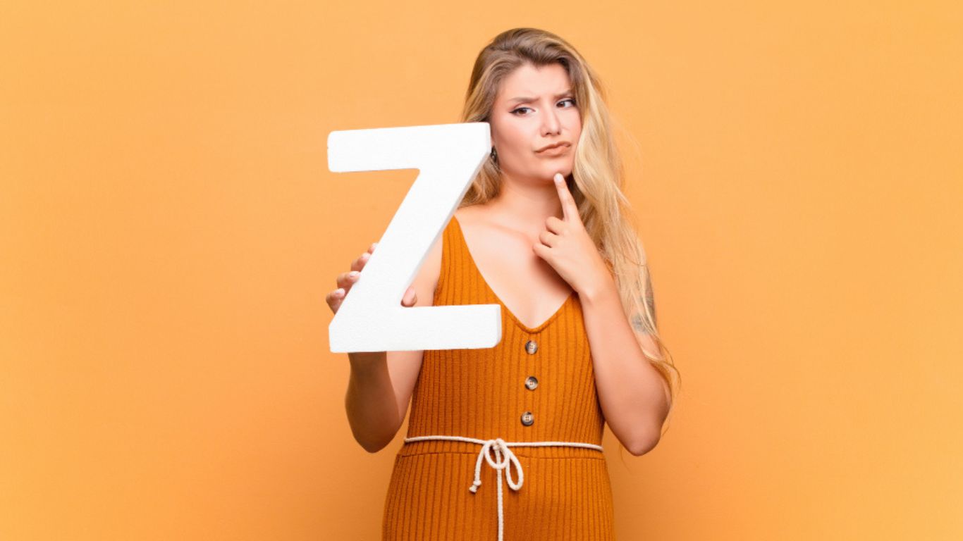 realistic image of a person holding a large letter “Z” in their hands with a thoughtful expression, as if asking how to pronounce the /z/ sound.