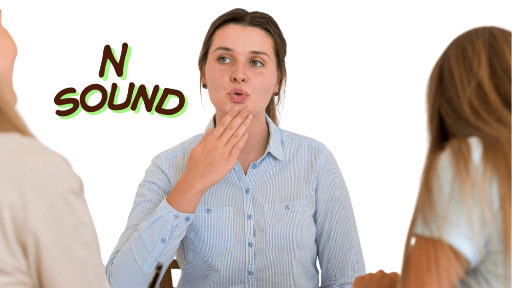 A person practicing the American N sound, showing tongue tip touching the alveolar ridge behind the upper front teeth.