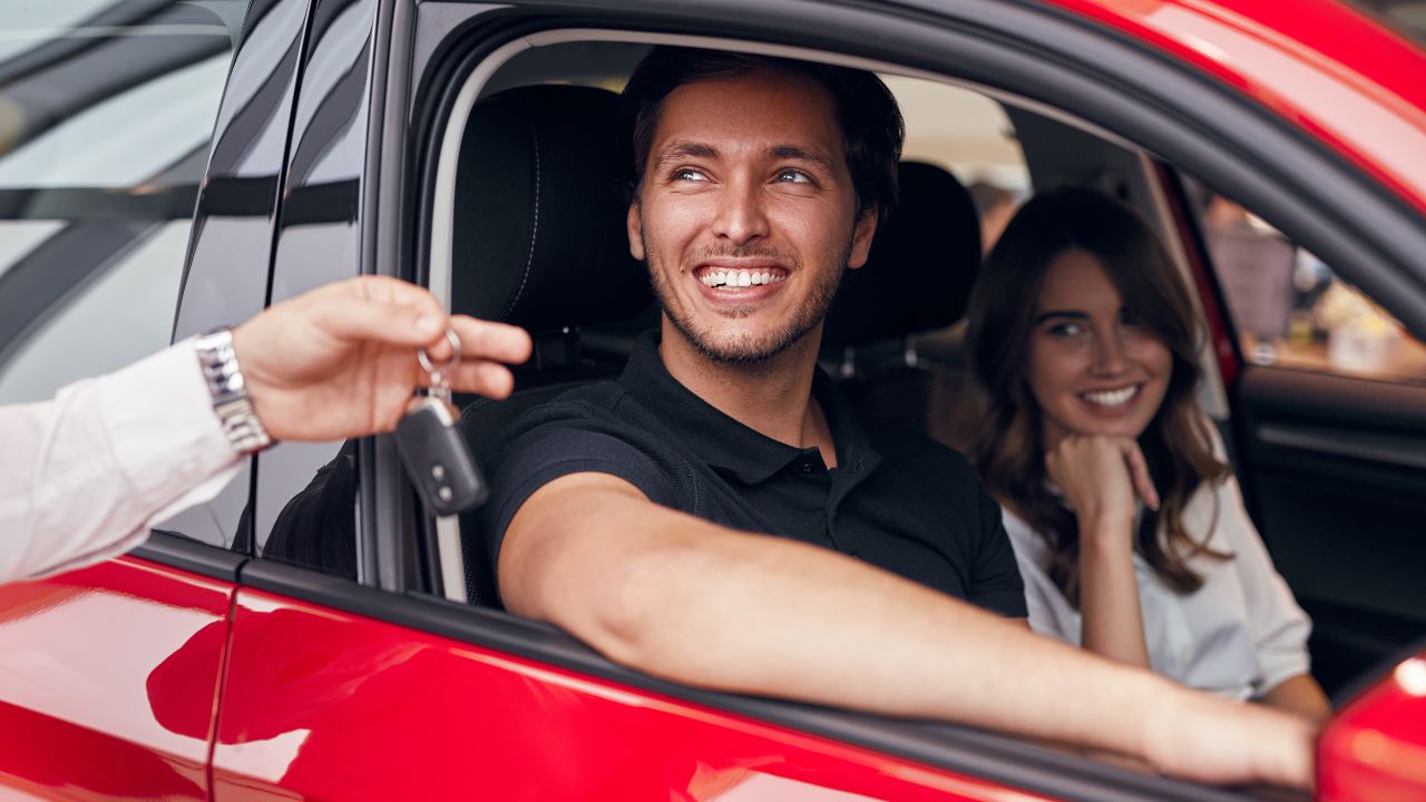 Customer at a car rental counter discussing rental terms and insurance options, learning essential English phrases for renting a car.